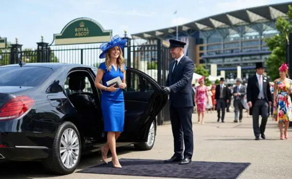Lady arriving at Royal Ascot in chauffeur driven car